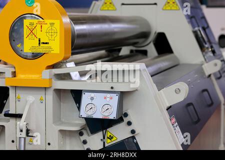 New 4 rolls hydraulic plate rolling machine in a plant. Selective focus. Stock Photo