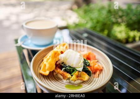 Potato waffles, Poached egg, avocado cream with salmon and egg . Healthy breakfast, protein. Restaurant dish.  Stock Photo