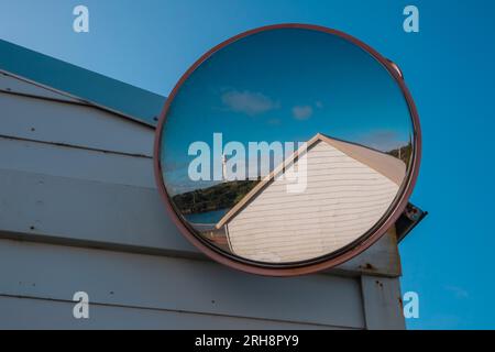 Photograph of the Currie Lighthouse as viewed from a large security mirror in the marina carpark on King Island in the Bass Strait of Tasmania Stock Photo