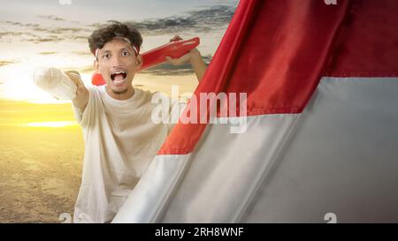 Indonesian man supporting the team when competing. Indonesian independence day Stock Photo