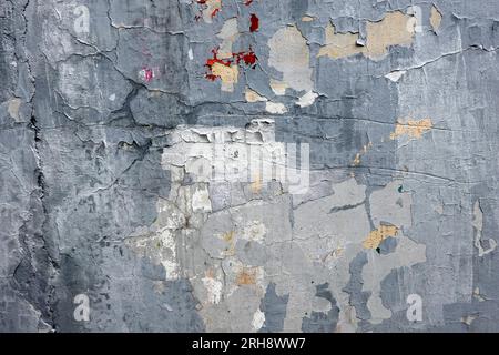 Old scratched uneven wall painted surface with damaged plaster as background front view close up Stock Photo