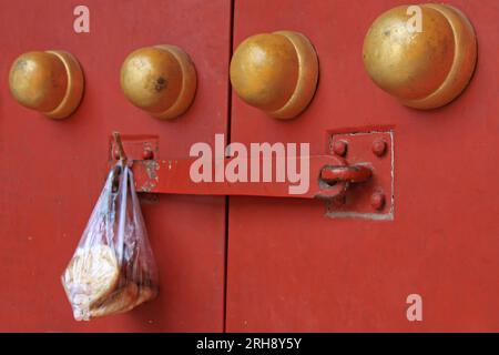 containing food plastic bag hang at the door, beijing, china Stock Photo