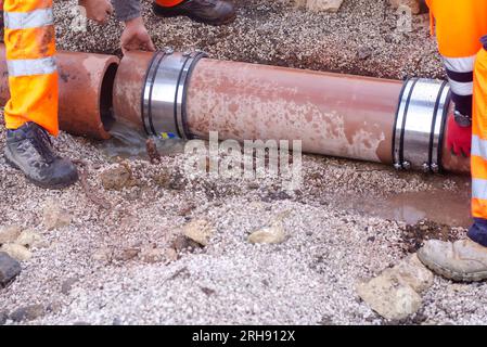 Broken drainage pipe repair Stock Photo