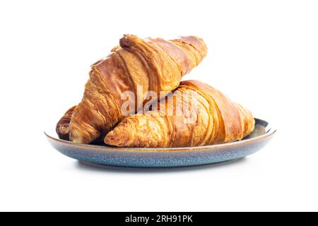 Fresh butter croissant on plate isolated on the white background. Stock Photo