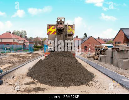 Ready-mix semi-dry concrete delivered on construction site by concrete wagon mixer Stock Photo