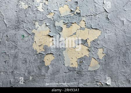 Scratched uneven wall painted surface with damaged gray plaster as background front view close up Stock Photo