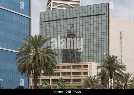 Reflection of the Boudl Tower / Narcissus Hotel in the glass facade of the King Faisal Foundation. King Fahd Rd, Al Olaya, Riyadh, Saudi Arabia Stock Photo