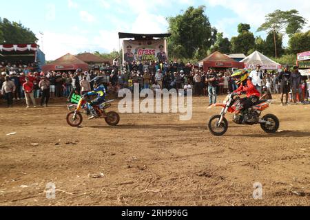 The style and action of the motorcycle racers and the enthusiasm of the spectators crowding the circuit Stock Photo