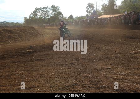 The style and action of the motorcycle racers and the enthusiasm of the spectators crowding the circuit Stock Photo