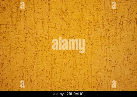 Background of yellow stone wall with drips. Stock Photo