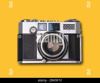 vintage old film camera on yellow background with shadow Stock Photo