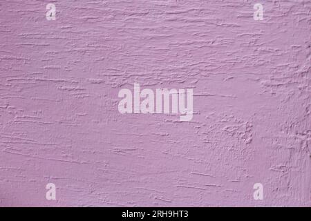 Abstract pink stucco grunge textured background. Wall is finished with decorative cement plaster. Facing. Copy space Stock Photo