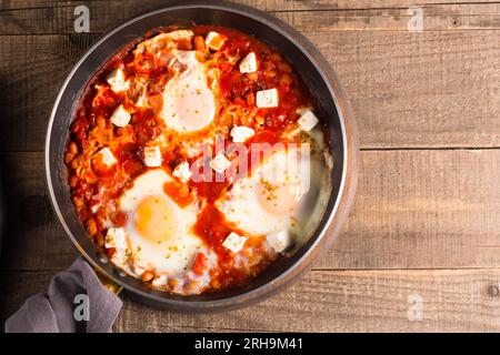 Shakshuka made of poached eggs in tomato pepper sauce Stock Photo