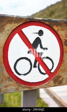Close up photo of old wooden no bicycles sign, selective focus. Stock Photo