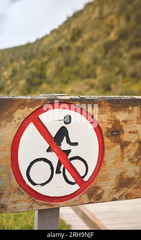Close up photo of old wooden no bicycles sign, selective focus. Stock Photo