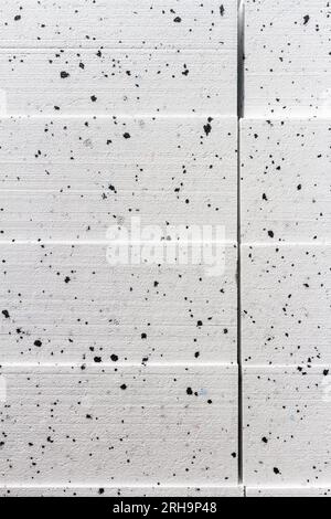 Abstract close up texture photo of compressed white with black dots styrofoam blocks Stock Photo