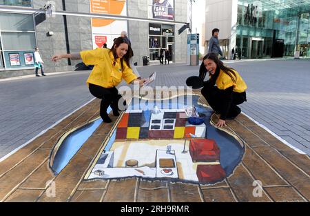 To celebrate the launch of the new 2010 catalogue IKEA brought the pages to life on the streets of Birmingham today. Peering into the kitchen outide the Bullring are Birmingham models Christie Jones (left) 22 of Shirley and Lucy Cusack 20 of Castle Bromwich. Stock Photo