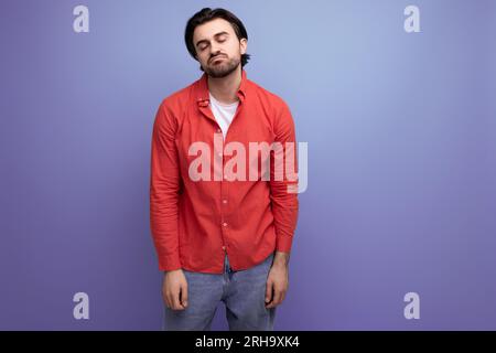 attractive brutal dark-haired 30s man in a red shirt Stock Photo