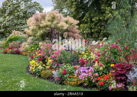 Beautiful flowers in many colors such as yellow, red, pink, orange and purple in the city park of the town of Epinal in the French Vosges Stock Photo