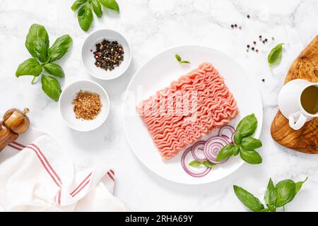 Mincemeat, forcemeat. Minced meat with ingredients for cooking, top view Stock Photo
