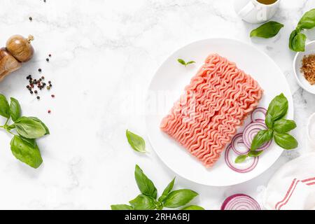 Mincemeat, forcemeat. Minced meat with ingredients for cooking, top view Stock Photo