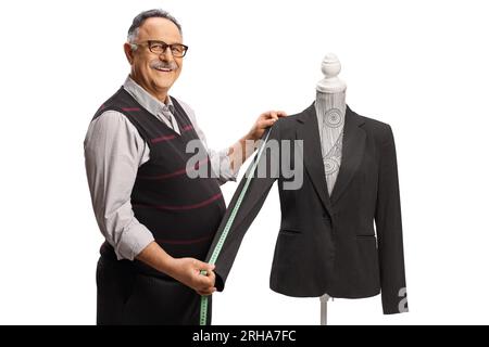 Mature tailor measuring a suit sleeve on a mannequin doll isolated on white background Stock Photo