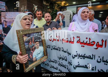 Nablus, Palestine. 15th Aug, 2023. A Palestinian female protester chants slogans while holding a portrait of a prisoner during the demonstration in solidarity with Palestinian prisoners detained by the Israeli occupation, in the city of Nablus in the occupied West Bank. Credit: SOPA Images Limited/Alamy Live News Stock Photo
