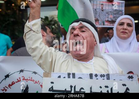 Nablus, Palestine. 15th Aug, 2023. A Palestinian protester with a flag chants slogans during the demonstration in solidarity with Palestinian prisoners detained by the Israeli occupation, in the city of Nablus in the occupied West Bank. Credit: SOPA Images Limited/Alamy Live News Stock Photo