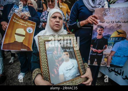 Nablus, Palestine. 15th Aug, 2023. A Palestinian female protester holds a portrait of a prisoner during the demonstration in solidarity with Palestinian prisoners detained by the Israeli occupation, in the city of Nablus in the occupied West Bank. (Photo by Nasser Ishtayeh/SOPA Images/Sipa USA) Credit: Sipa USA/Alamy Live News Stock Photo