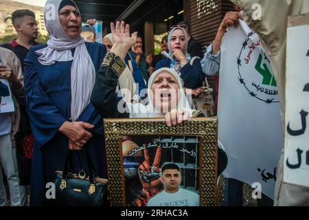 Nablus, Palestine. 15th Aug, 2023. A Palestinian female protester chants slogans while holding a portrait of a prisoner during the demonstration in solidarity with Palestinian prisoners detained by the Israeli occupation, in the city of Nablus in the occupied West Bank. (Photo by Nasser Ishtayeh/SOPA Images/Sipa USA) Credit: Sipa USA/Alamy Live News Stock Photo