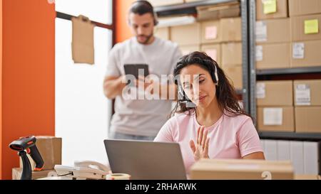 Man and woman ecommerce business workers having video call working at office Stock Photo