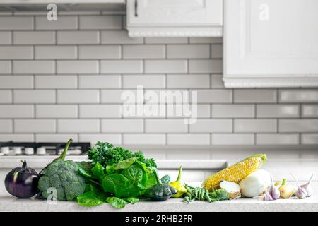 A set of fresh raw vegetables on the table in a modern kitchen, copy space. Stock Photo