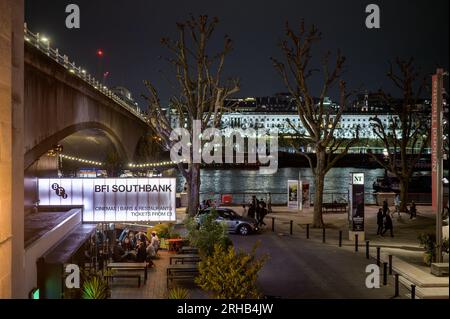 LONDON - April 22, 2023: Capture the magic of London at night with the BFI Southbank sign, Waterloo Bridge, and Somerset House illuminated by city lig