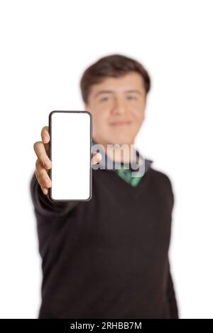Boy showing the screen of his mobile phone isolated on white background. Selective focus. Stock Photo