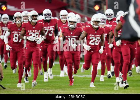 Denver Broncos players run on the field led by McTelvin Agim (95), Marquiss  Spencer (51), Justin Strnad (40), Jamar Johnson (41) with other following  to start an NFL football preseason game against