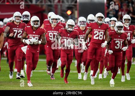 Denver Broncos players run on the field led by McTelvin Agim (95), Marquiss  Spencer (51), Justin Strnad (40), Jamar Johnson (41) with other following  to start an NFL football preseason game against