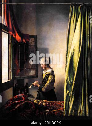 Johannes Vermeer’s Girl Reading a Letter by an Open Window famous painting. Original from Wikimedia Commons. Stock Photo