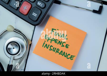 Concept of Final Expense Insurance write on sticky notes with stethoscope and calculator isolated on Wooden Table. Stock Photo