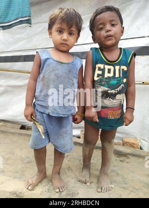 Portrait of two children at the Balukhali refugee camp. Approximately 919,000 Rohingya refugees are living at the Kutupalong and Nayapara camps in Cox’s Bazar region — which have grown to become some of the largest and most densely populated camps in the world. Bangladesh. Stock Photo