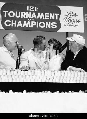 Las Vegas, Nevada:  1963 Professional golfer Jack Nicklaus kisses his wife after winning the Tournament of Champions at the Desert Inn Country Club. Desert Inn owner Wilbur Clark (L) and journalist Walter Winchell (R) are spectators. Stock Photo