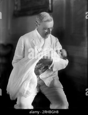 Washington, D.C.  1915 President Woodrow Wilson holding his granddaughter Ellen Wilson McAdoo. Stock Photo