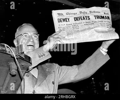 St. Louis, MIssouri: November, 1948. President Harry Truman holds up a copy of the Chicago Daily Tribune declaring his defeat to Thomas Dewey in the presidential election. Stock Photo