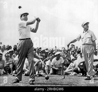 Rockville, Maryland: 1953 Vice-President Richard Nixon tees off at the National Celebrities Open Tournament at the Woodmont Country Club. Bob Hope at right smiles as he watches the ball heading for spectators. Nixon, a newcomer to the sport, twice sent spectators ducking on the first hole. Stock Photo