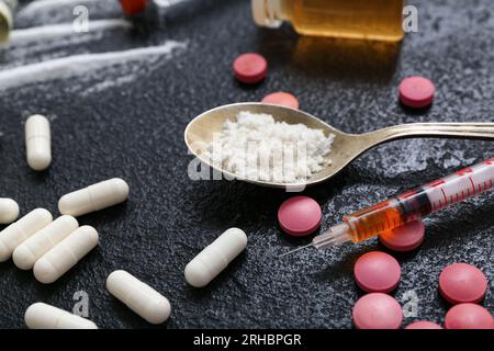 Different drugs and syringe on dark background, closeup Stock Photo