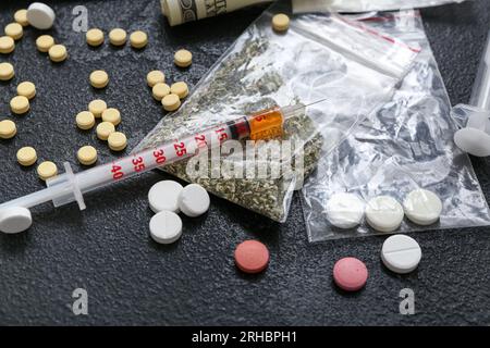 Different drugs and syringe on dark background Stock Photo