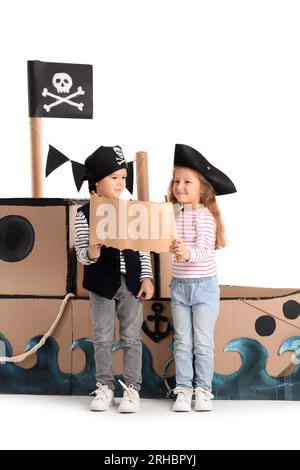 Cute little pirates playing with treasure map on white background Stock Photo