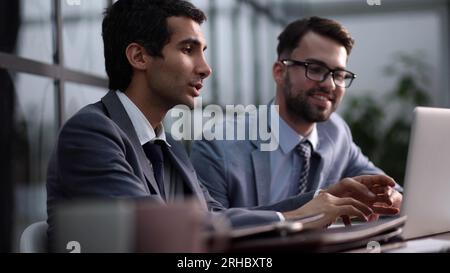 Young business people working in the office with a laptop on the table Stock Photo