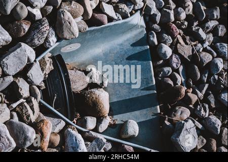 underground drainage storm drain with winged walls surrounded by rock for erosion control  Stock Photo