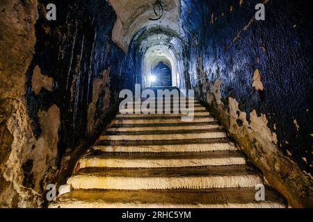 Old vaulted corridor of Soviet bunker, echo of Cold War. Stock Photo