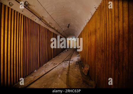 Old vaulted corridor of Soviet bunker, echo of Cold War. Stock Photo